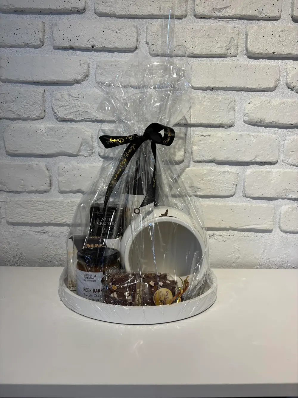 Boho white tray gift set with red wine, Cherrington water crackers, Beer Barrel peach salsa, local chocolates and a white accent pot
