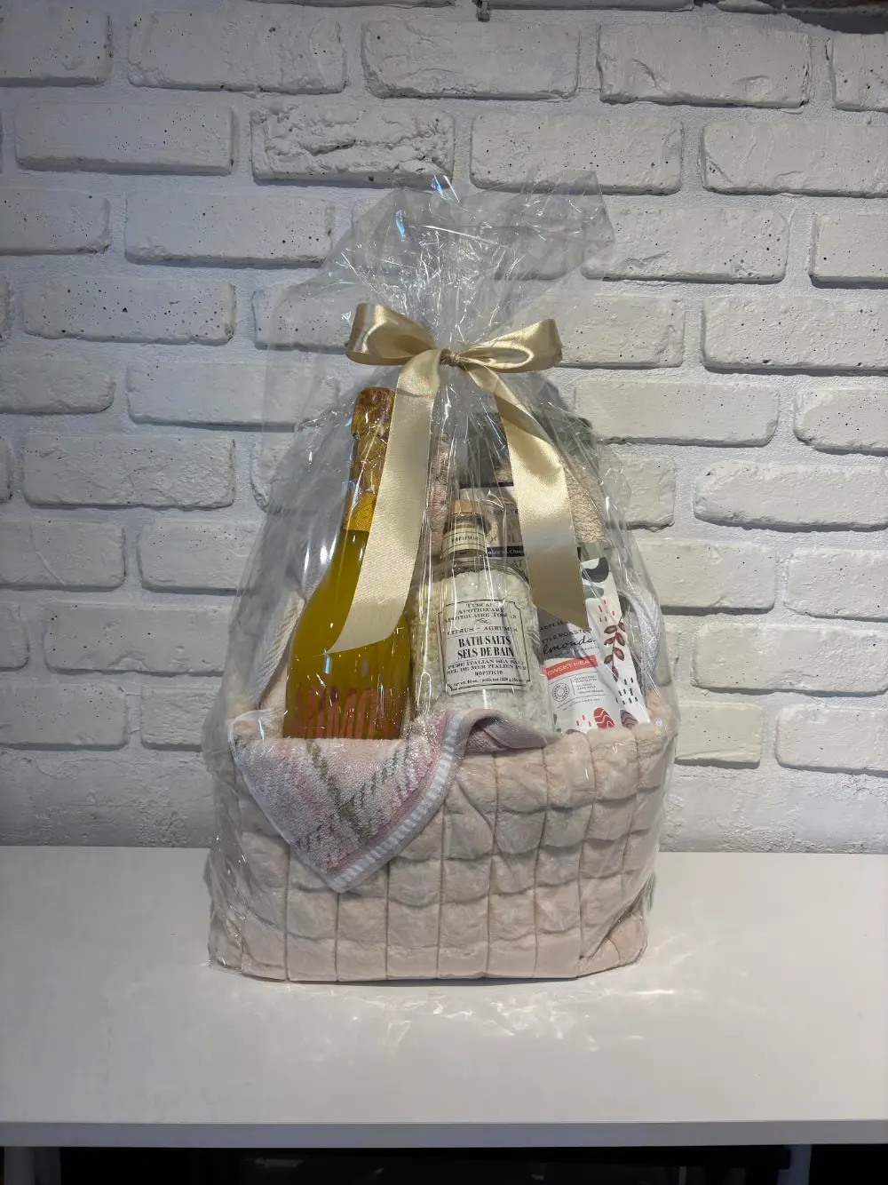 Pamper spa gift basket in a soft pink sherpa basket with bath salts, bath towel, bath mitt, Mimosa Opera Prima and icewine chocolate