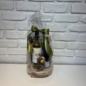 White wine on decorative pedestal with apple chutney and local chocolates