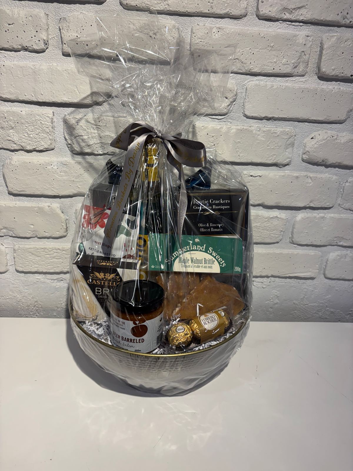 White Wine in a Hammered-Finish Metal Bowl gift basket with Castello brie, rustic crackers, maple walnut brittle, peach salsa and Ferrero Rocher
