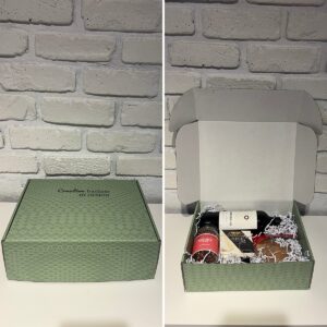 Creative Baskets by Design gift box shown closed and open, with red wine, Castello brie, popcorn kernels and almond brittle inside